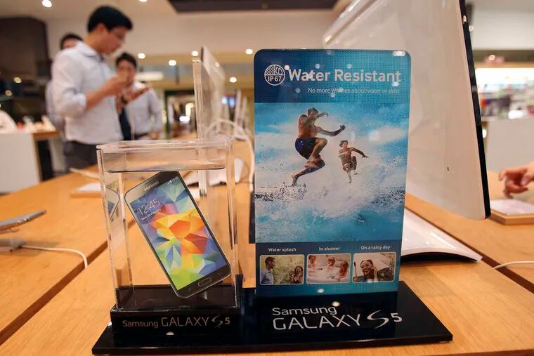 A Samsung smartphone is displayed at the company's showroom in Seoul, South Korea. Samsung Electronics Co., the world's biggest smartphone maker, reported a bigger-than-expected fall in quarterly profit Thursday. Marketing costs for its smartphones rose as Samsung tries to fend off competition from Apple and Chinese producers. Net income, excluding minority interests, fell 18 percent to $6 billion in the three months ended in June.