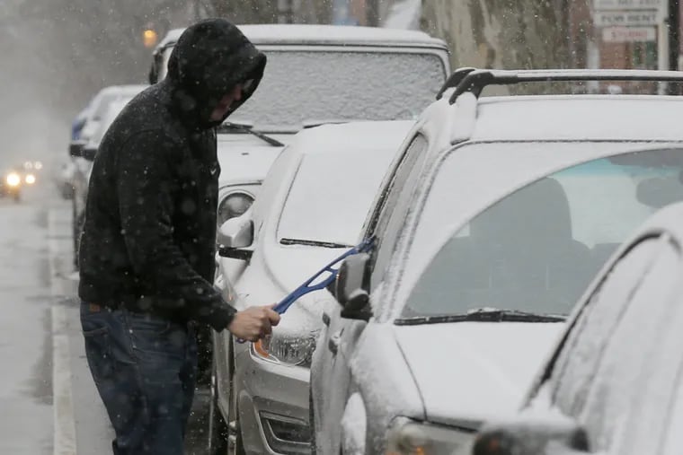 Paul Lench cleans off his car along the 1000 block of Pine Street with snow falling on Saturday, Jan. 7, 2017.