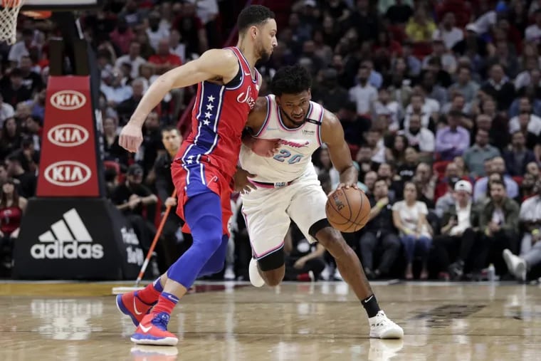 Sixers’ guard Ben Simmons, left defends Miami’s Justice Winslow during the Sixers’ loss on March 8.