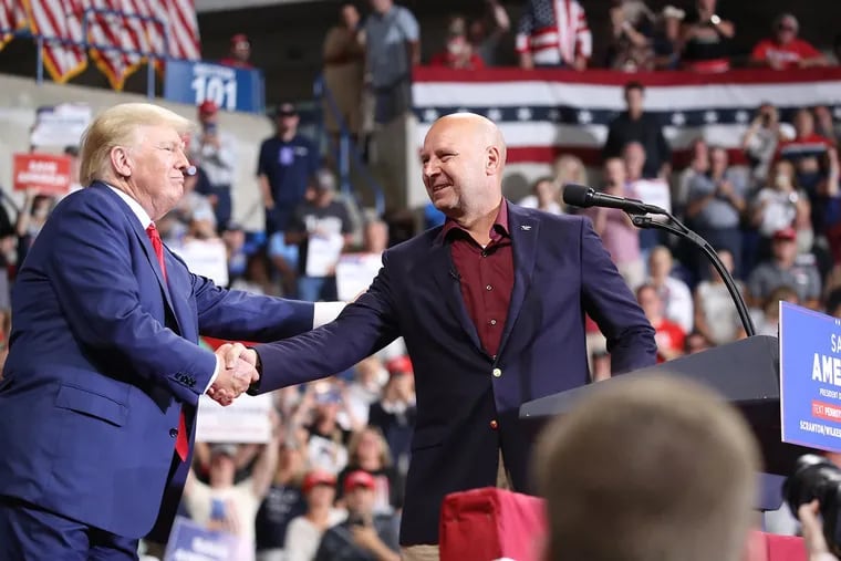 Then-Pennsylvania Republican gubernatorial candidate Doug Mastriano is greeted by former president Donald Trump at a rally to support local candidates at the Mohegan Sun Arena in September.