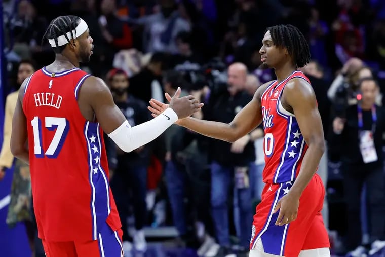 Sixers guards Tyrese Maxey and Buddy Hield celebrate after the Sixers beat the Cleveland Cavaliers at home on Friday night.