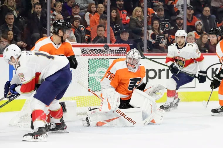 Flyers goaltender Carter Hart watches the puck with teammates Matt Niskanen (left) and Ivan Provorov against the Florida Panthers' Mark Pysyk (left) and Colton Sceviour on Feb. 10.