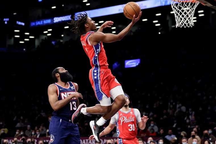 Sixers guard Tyrese Maxey drives to the basket past Brooklyn Nets guard James Harden (13) during the first half of an NBA basketball game Thursday. He finished the game with 25 points.