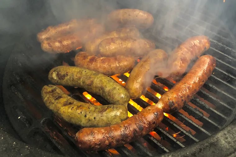 A selection of links from the Heavy Metal Sausage pop-up at In The Valley —  a seasonal ramp sausage, smoky kielbasa, and spicy fennel — sizzle on the grill alongside sausages from Primal Supply.
