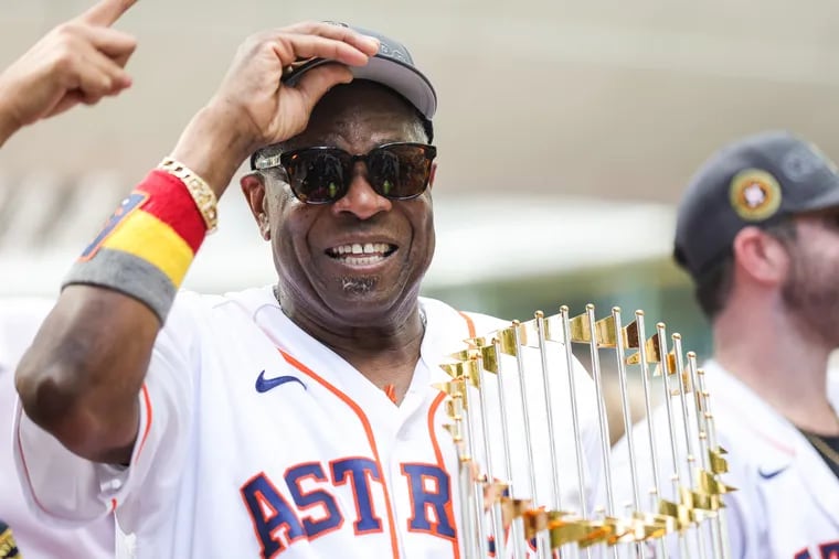 Houston Astros manager Dusty Baker cradles the World Series trophy during the team’s championship parade in November. The Astros begin spring training favored to win back-to-back titles, something no MLB team has done in more than 20 years. (Photo by Carmen Mandato/Getty Images)