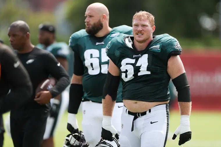 Eagles offensive lineman Cam Jurgens walks off the field with Lane Johnson behind him after practice during training camp at the NovaCare Complex in Philadelphia on Tuesday, Aug. 1, 2023.
