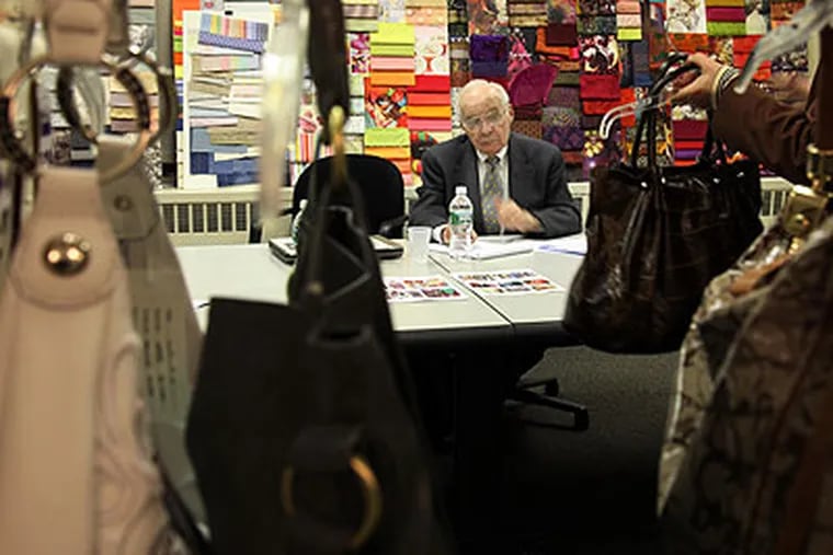 Albert Boscov, owner of Boscov's Department Stores, examines merchandise at The Doneger Group in New York City during his weekly buying trip on March 18, 2009. (Laurence Kesterson / Staff Photographer)