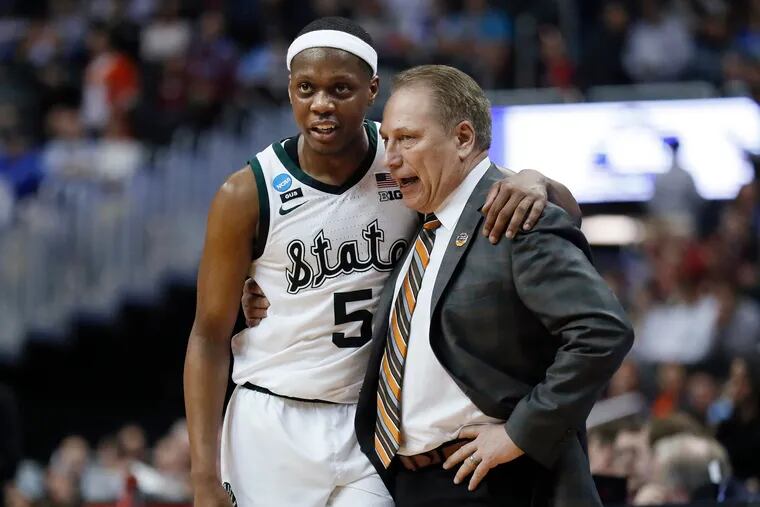 Michigan State guard Cassius Winston (5) with his arm around coach Tom Izzo after an 80-63 win over LSU in an East Region semifinal.