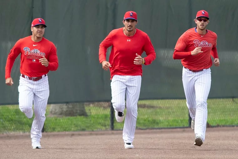 Phillies pitchers (from left) JoJo Romero, Zach Eflin, and Aaron Nola running during spring training last February.