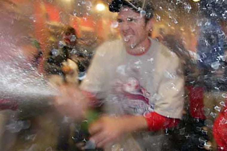 Chase Utley sprays champagne after the Phillies’ victory in the World Series. The brand he's brandishing, Domaine Ste. Michelle Brut, is also good for drinking. (YONG KIM / Staff Photographer)