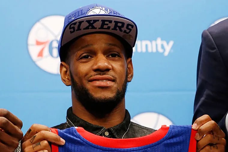 Pierre Jackson poses for a photo after a basketball news conference at the team's practice facility, Saturday, June 28, 2014, in Philadelphia. (Matt Slocum/AP)