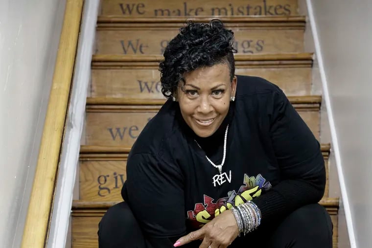 The Rev. Michelle Simmons, founder and executive director of Why Not Prosper, on the staircase at a Why Not Prosper recovery home in Philadelphia on April 7, 2022.