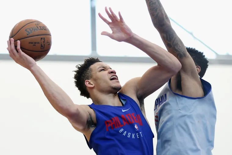 Kentucky forward Kevin Knox, left, attempts a layup around Cincinnati guard-forward Jacob Evans during a pre-draft workout at the Sixers Training Complex in Camden, N.J., on Friday, June 15, 2018. TIM TAI / Staff Photographer