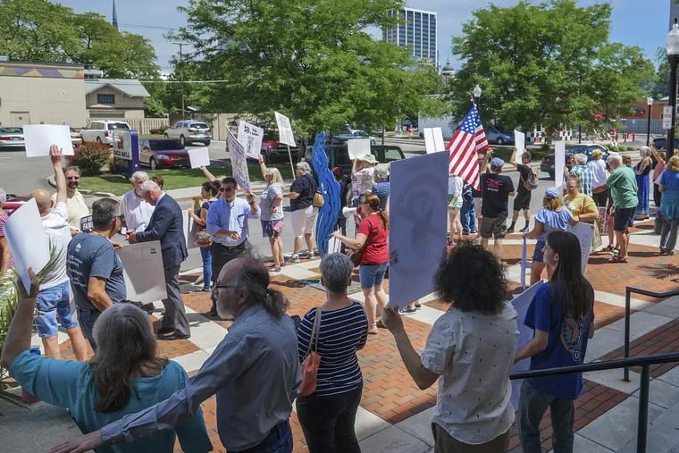 People line up to protest U.S. Attorney General Jeff Sessions and immigration reform at Parkview Field in Fort Wayne, Ind., in June, when he announced policies that would block people fleeing gang violence and domestic abuse from seeking asylum in the U.S.