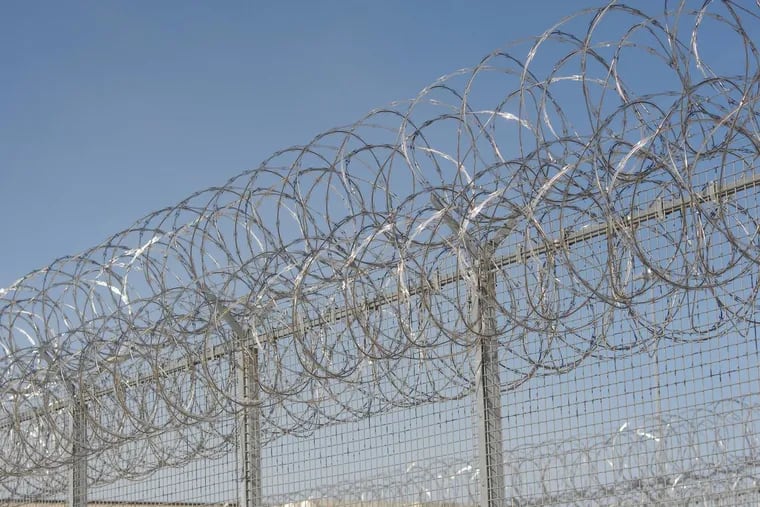 Barbed wire fencing at the State Correctional Institution Phoenix, in Skippack Township, Pennsylvania. (WILLIAM THOMAS CAIN / For The Philadelphia Inquirer)