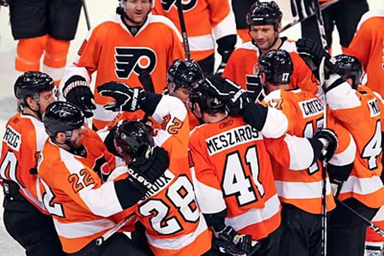 The Flyers celebrate after Andrej Meszaros' game-winning goal over the Islanders. (Steven M. Falk/Staff Photographer)
