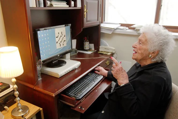 Bernice Gordon makes a crossword puzzle using her computer at her Center City apartment on Jan. 15, 2014. ( AKIRA SUWA  /  Staff Photographer )