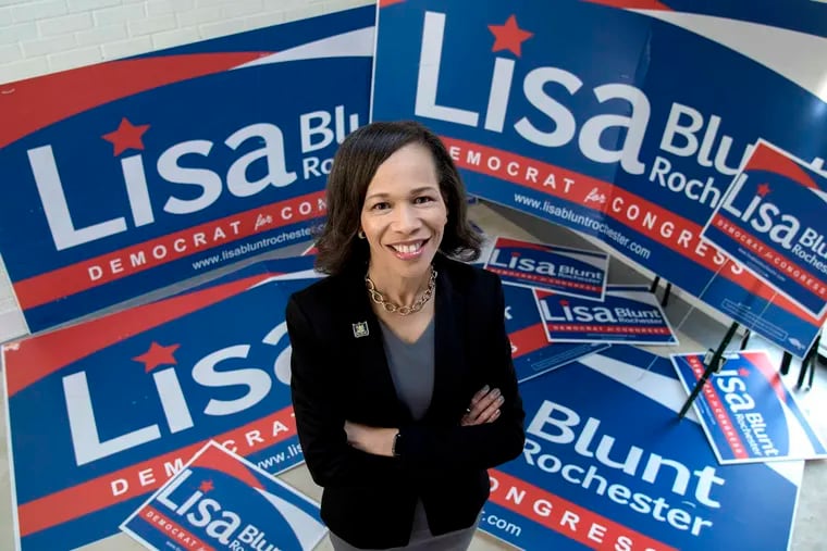 File photo: Lisa Blunt Rochester, the U.S. representative for Delaware’s at-large congressional district., stood amid campaign posters in her Wilmington office on November 2, 2016. She became the first woman and first African American elected to Congress from the state.