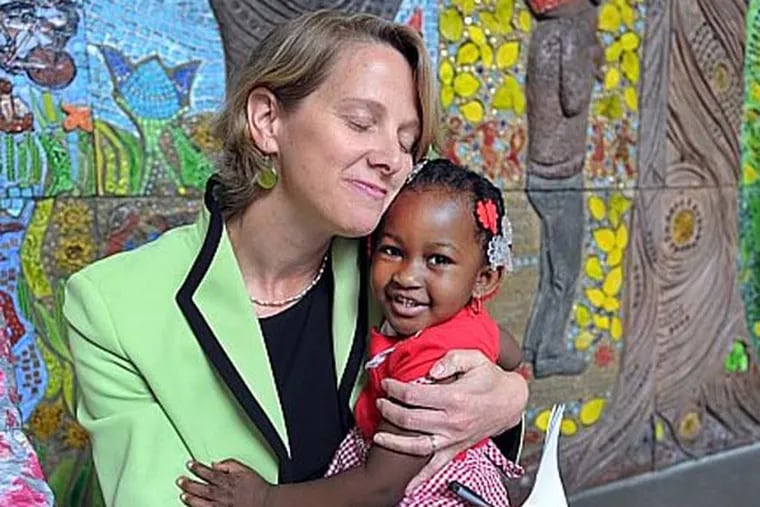 File photo: Mariana Chilton, associate professor and director of the Center for Hunger-Free Communities at the Drexel University School of Public Health, hugs Joe-anna Parks, 3, at an event at the St. Christopher's Hospital for Children in Philadelphia in May 2011.