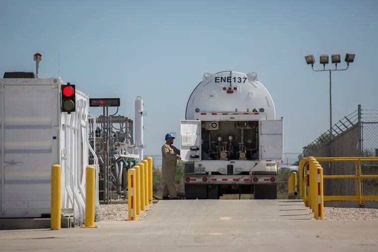 FILE - A worker opens up the back of a liquefied natural gas to fill up the tank in George West, Texas on April 2, 2019. An explosion at Freeport LNG in Texas on Wednesday, June 8, 2022, has left nearby residents rattled and is taking a substantial amount of the fuel off the market at a time when global demand is soaring. (Marie D. De Jesús/Houston Chronicle via AP, File)