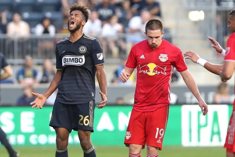 Auston Trusty, left, of the Philadelphia Union reacts after missing an attempt to head the ball into the goal against the New York Red Bulls at Talen Energy Stadium on June 8, 2019.  Alex Muyl of the Red Bulls is right.