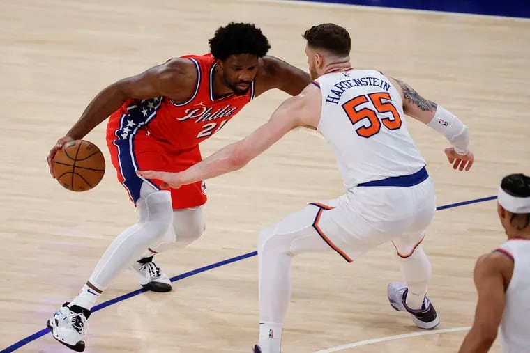 Joel Embiid dribbles against New York Knicks center Isaiah Hartenstein in the first round of the NBA Eastern Conference playoffs on April 20.