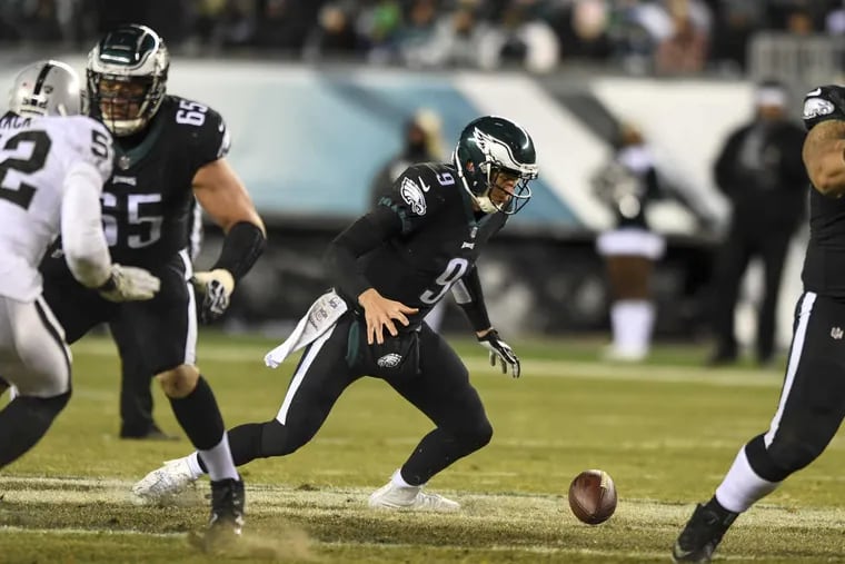 Eagles quarterback Nick Foles fumbles the ball on the snap from center in the second quarter of the game at Lincoln Financial Field on Christmas. Foles recovered the ball.