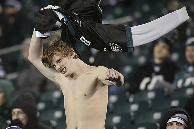 An Eagles fan takes his jersey off as his team loses to the
Bengals at Lincoln Financial Field, Thursday, December 13, 2012. (Steven M. Falk/Staff Photographer)