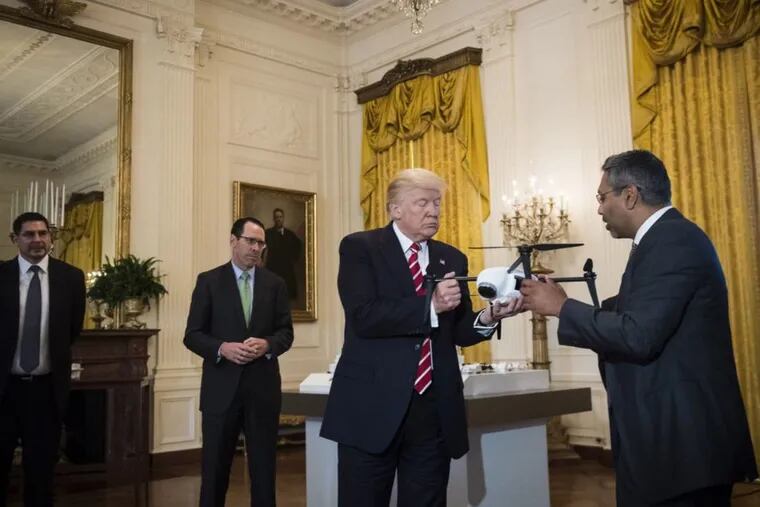 George Mathew, chief executive of Kespry, shows a drone to President Trump during the &quot;American Leadership in Emerging Technology&quot; event in the East Room of the White House last June.