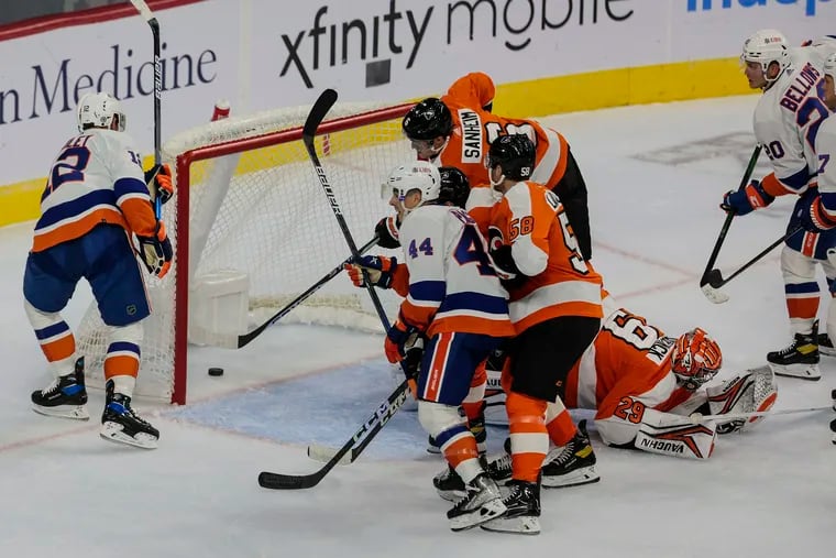 Flyers goalie Troy Grosenick can not stop the goal of Islanders Josh Bailey, left during the second period at the Wells Fargo Center in Philadelphia, Tuesday, October 4, 2022.