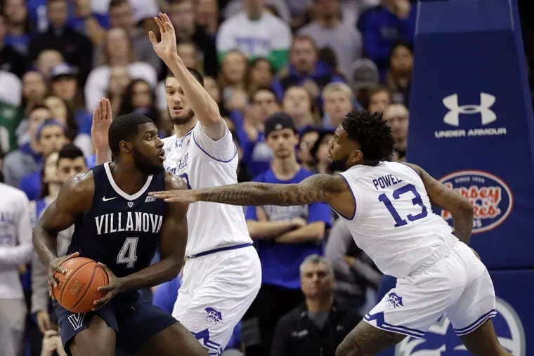 Eric Paschall (left) tries to get past Seton Hall defenders Myles Powell and Sandro Mamukelashvili during the Wildcats' loss on Sunday.