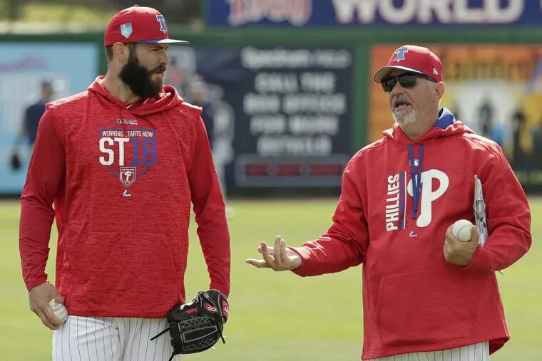 Phillies pitcher Jake Arrieta, left, talks with pitching coach Rick Krannitz during spring training.