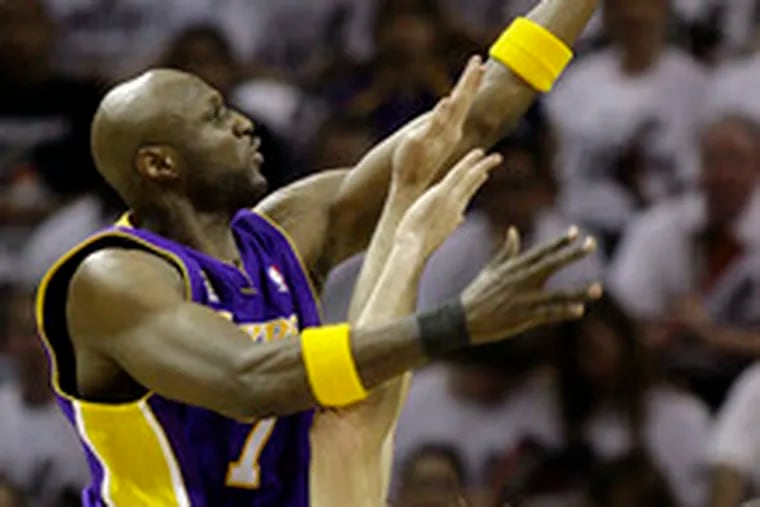 The Lakers&#0039; Lamar Odom goes over the Spurs&#0039; Fabricio Oberto in the Western finals&#0039; Game 4. It ended too late for this edition.