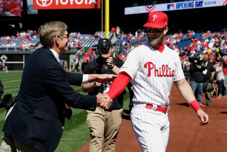 Phillies star Bryce Harper, right, shakes hands with owner John Middleton before the 2019 season opener at Citizens Bank Park.