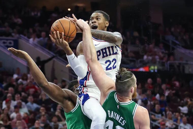 Sixers' Richaun Holmes gets fouled by Celtics' Aron Baynes (46) as he leaps over Guerschon Yabusele during the 3th quarter at the Wells Fargo Center in Philadelphia, Friday, October 6, 2017. Boston beats Philadelphia 110-102. STEVEN M. FALK / Staff Photographer