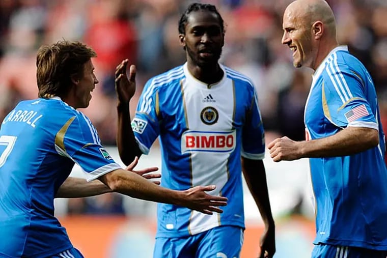 Philadelphia Union forward Conor Casey (6) celebrates his goal with
Brian Carroll (7) and Keon Daniel (26) against D.C. United during the
first half of an MLS soccer match, Sunday, April 21, 2013, in
Washington. (AP Photo/Nick Wass)