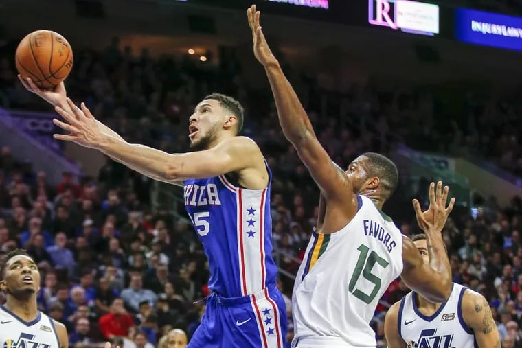 Sixers guard Ben Simmons drives to the basket past Utah Jazz forward Derrick Favors during the third quarter.