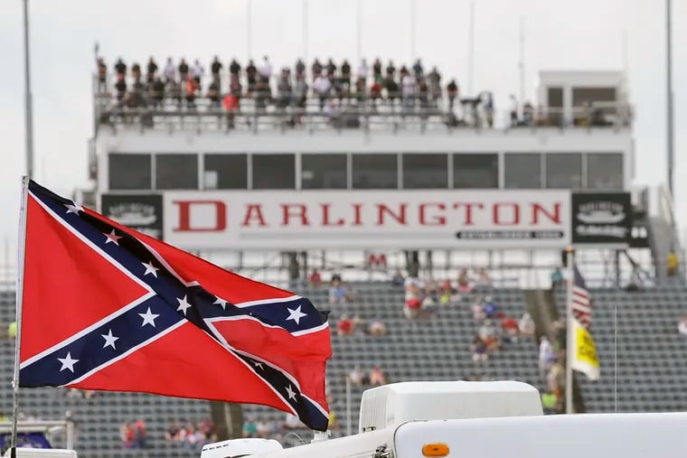 A Confederate flag flies in the infield before a NASCAR Xfinity Series race at Darlington Raceway in South Carolina on Sept. 5, 2015. Bubba Wallace, the only African-American driver in the top tier of NASCAR, called for a ban on the Confederate flag in the sport that is deeply rooted in the South. NASCAR finally obliged on Wednesday. (Terry Renna, AP File Photo)