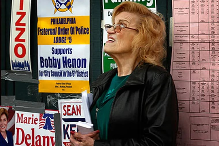 Philadelphia City Commissioner Marge Tartaglione eyes the sky for signs of rain while campaigning outside her polling place at 1466 E. Cheltenham Ave. on Tuesday afternoon. (Laurence Kesterson / Staff Photographer)