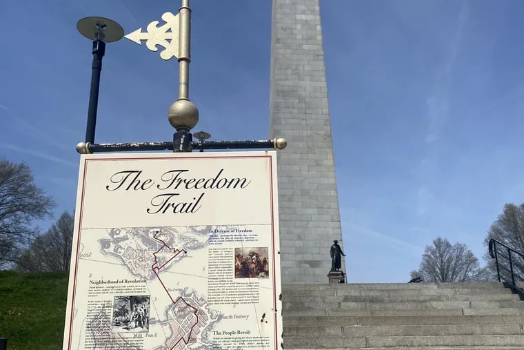 A sign for the Freedom Trail in front of the Bunker Hill Monument in Charlestown, just outside of Boston. The monument marks the end or beginning of the Freedom Trail, depending on which way you take it.