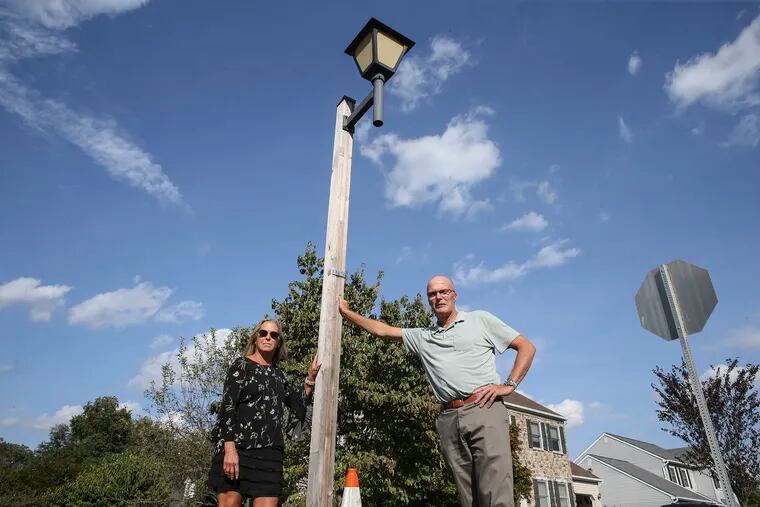 Hundreds of thousands -- perhaps millions -- of small cell antennas will be placed on light poles and traffic lights over the next several years, mostly without homeowner or resident consent.  Doylestown Township homeowner Dawn van Rijn and her husband Paul stand with the light pole that would be replaced with a tower four times taller in their front yard.