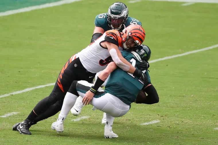 Eagles QB Carson Wentz gets sacked by Cincinnati Bengals defensive end Sam Hubbard in the first quarter of Sunday's 23-23 tie.