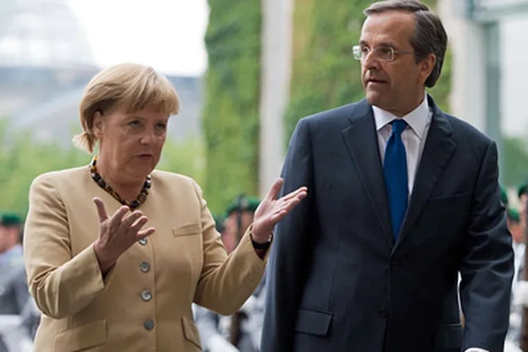 German Chancellor Angela Merkel and Greek Prime Minister Antonis Samaras in August. Samaras says he welcomes the visit, but public sentiment makes her an object of anger. MAJA HITIJ / Associated Press