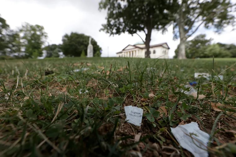 Glassine heroin bags, including one with a "Santa Muerte" stamp, sits on the lawn around McPherson Square Library.