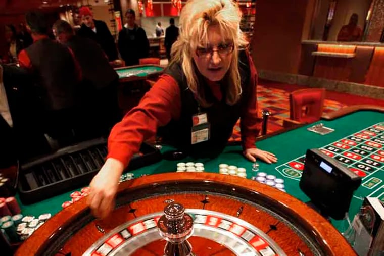 Laureen Jolley spins the roulette wheel in the new Parx East Casino in the old Philly Park building on opening day, December 22. 2010.  (Laurence Kesterson / Staff Photographer)
