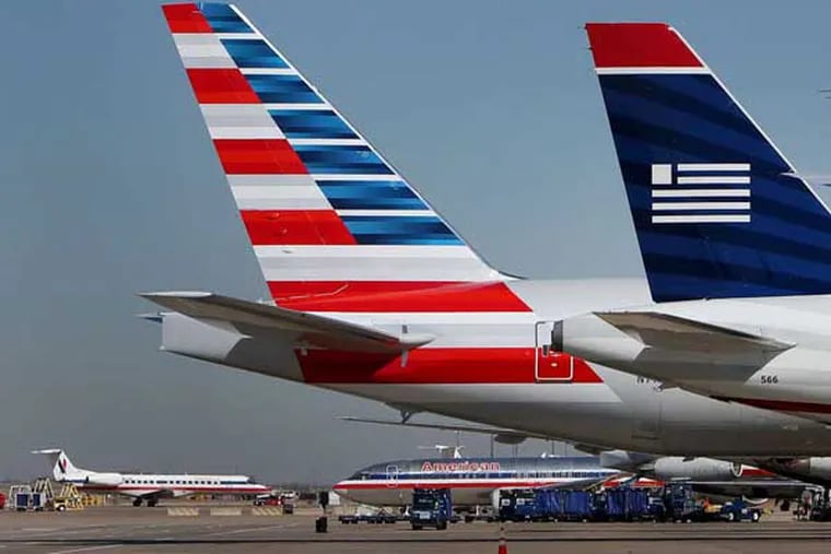 These former US Airways and American Airlines jets are now part of the same operation. Photographer: Mike Fuentes/Bloomberg