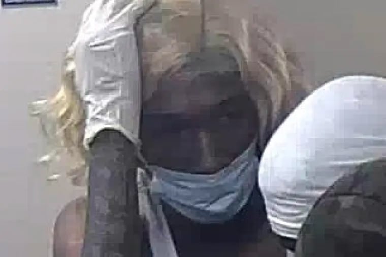 A still from surveillance footage shows a man, who FBI agents have identified as Raphael Shaw, inside a Wells Fargo branch in the ParkWest Town Center on May 31, moments before he allegedly returned with accomplices and a forklift to steal the cash vault.