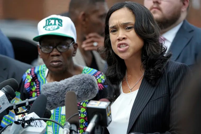FILE - In this July 27, 2016 file photo, Baltimore State's Attorney Marilyn Mosby, right, holds a news conference near the site where Freddie Gray was arrested after her office dropped the remaining charges against three Baltimore police officers awaiting trial in Gray's death, in Baltimore. Mosby will no longer prosecute any marijuana possession cases, regardless of the quantity of the drug or an individual’s prior criminal record, authorities announced Tuesday, Jan. 29, 2019.  (AP Photo/Steve Ruark)