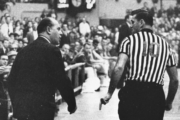 Legendary Boston Celtics coach Red Auerbach argues with referee Earl Strom in a 1962 game.