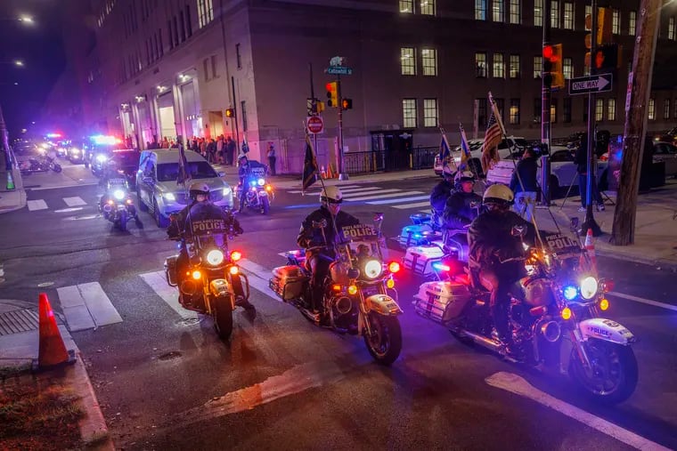 Procession of Philadelphia police vehicles with body of fallen officer in hearse leaves police headquarters October 13. Officer Richard Mendez was shot and killed and Raul Ortiz was wounded at Philadelphia International Airport.